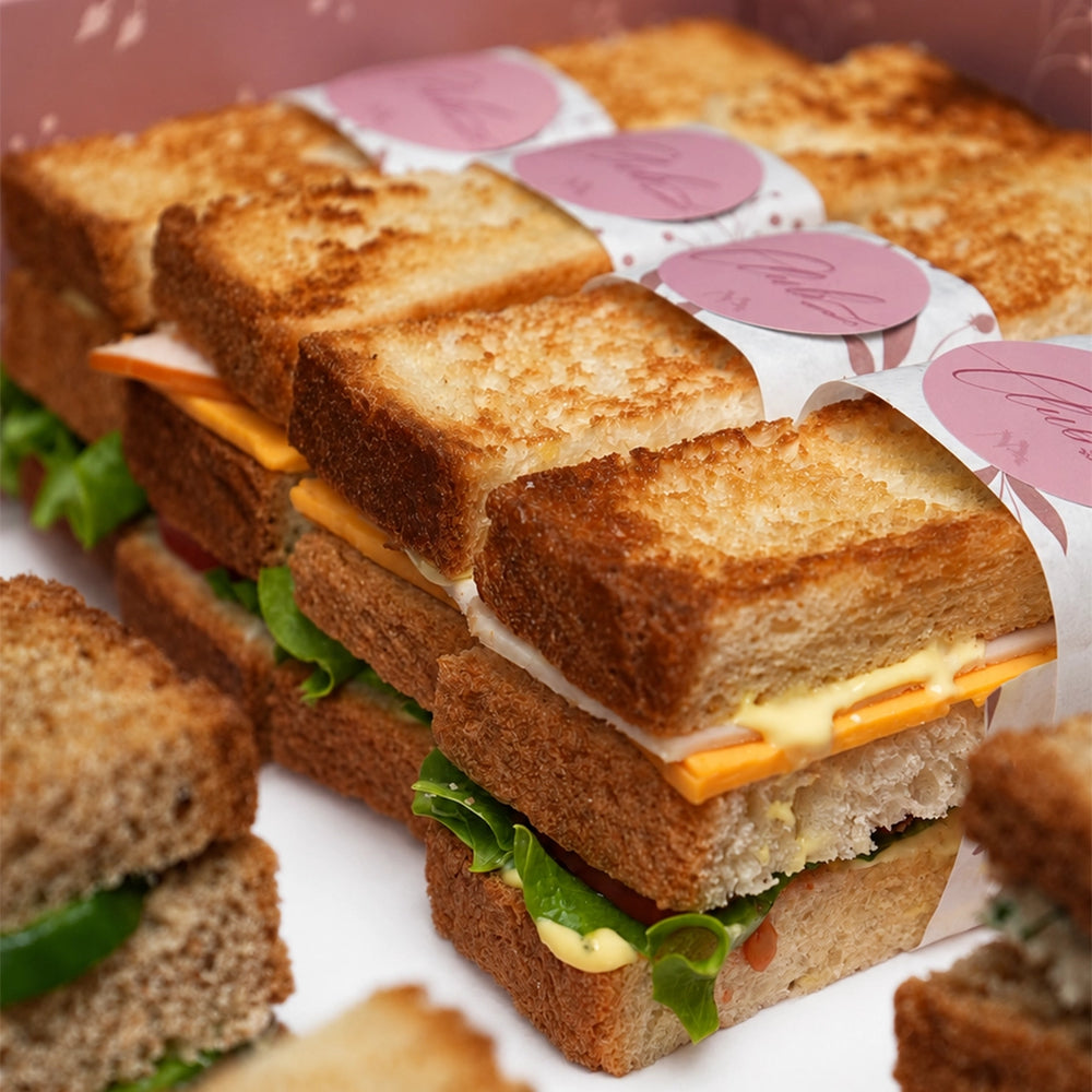 Mazzah Toast Sandwich Box with assorted toast sandwiches — overhead view